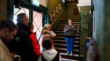 Group of people being led on a tour of the Theatre in the Box Office